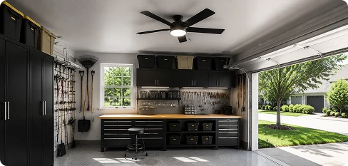 Flush mount garage ceiling fan installed on a low ceiling above an organized residential workshop
