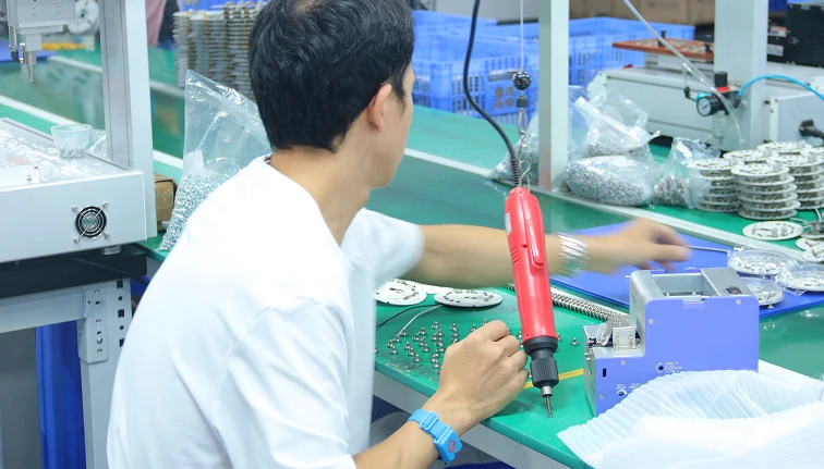 technician inspecting ceiling fan components in quality control lab showing strict testing process for OEM manufacturing and export compliance standards