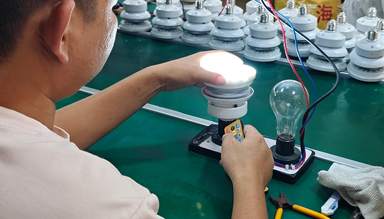 Technician performing quality control testing on ceiling fan with LED light to ensure safety and performance standards
