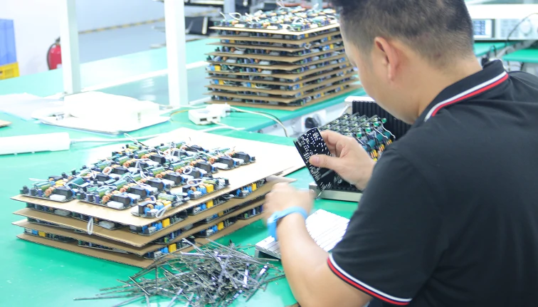 Worker performing strict quality control testing on crystal bladeless ceiling fan light luxury series in modern factory inspection laboratory