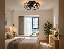18 inch black industrial cage flush mount ceiling fan light installed in a low ceiling modern apartment bedroom