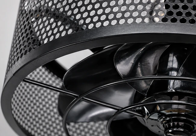 Close-up view of the metal mesh cage and hidden blades on an 18-inch black ceiling fan.