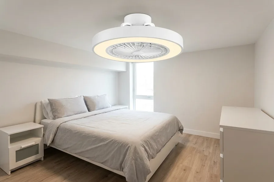 Low profile apartment ceiling fan installed safely in a low ceiling bedroom.