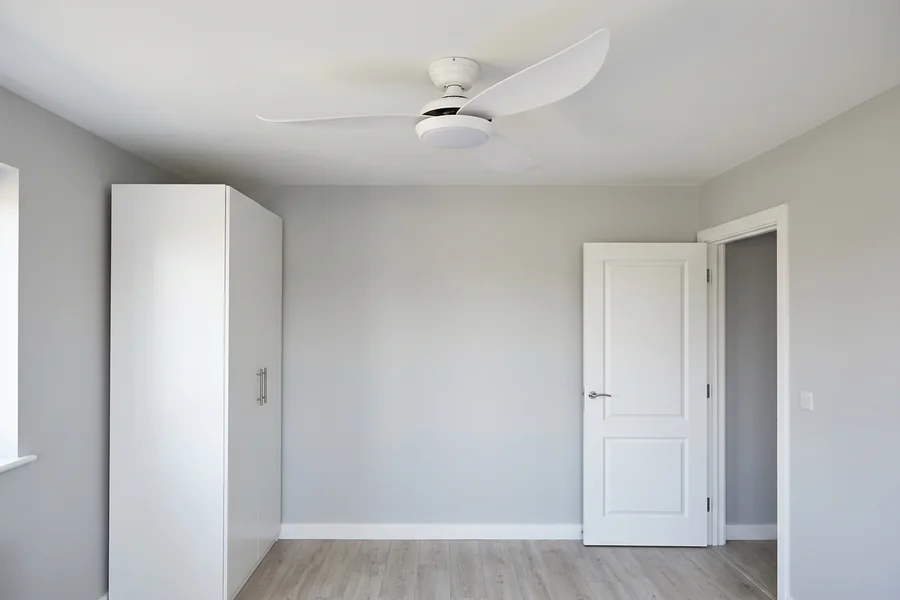 Flush mount ceiling fan light installed with safe clearance in a low room