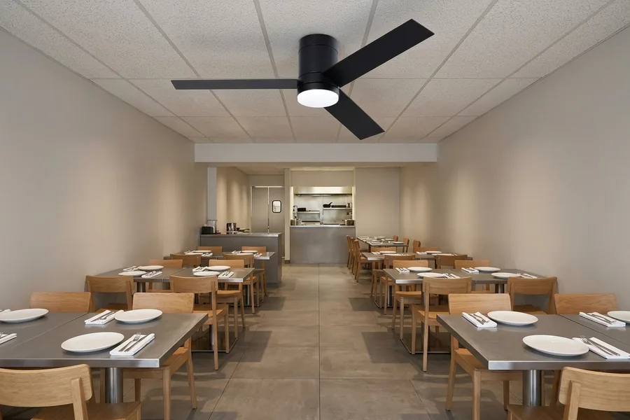 Restaurant ceiling fan airflow planned around kitchen entrance and seating