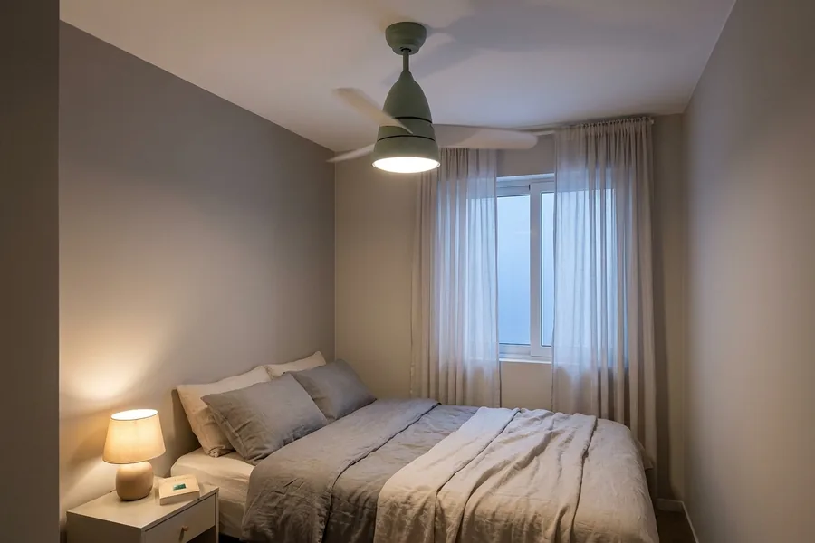 Small room ceiling fan providing gentle low-speed airflow for bedroom comfort.