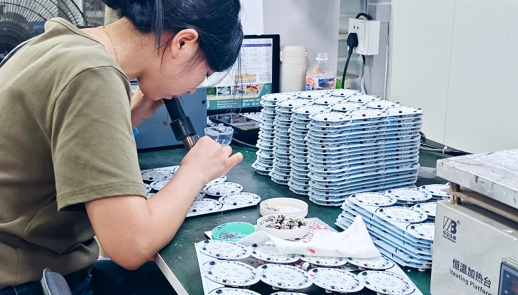 Fan light E27 production process with assembly line manufacturing workers